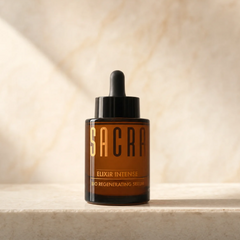 SACRA Elixir Intense Bio Regenerating Serum, amber glass dropper bottle on marble