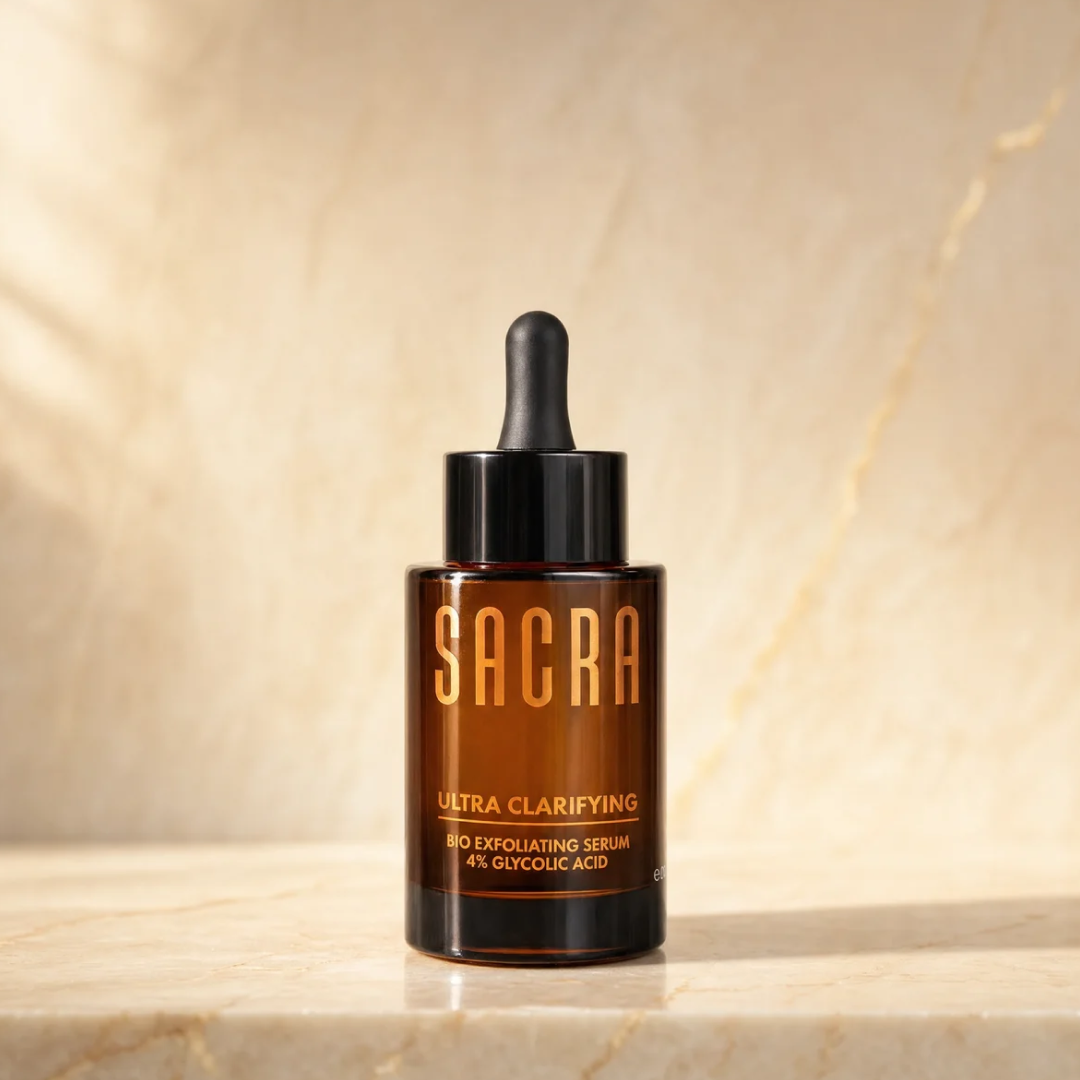 SACRA Ultra Clarifying Bio Exfoliating Serum 4% Glycolic Acid, amber glass dropper bottle on marble