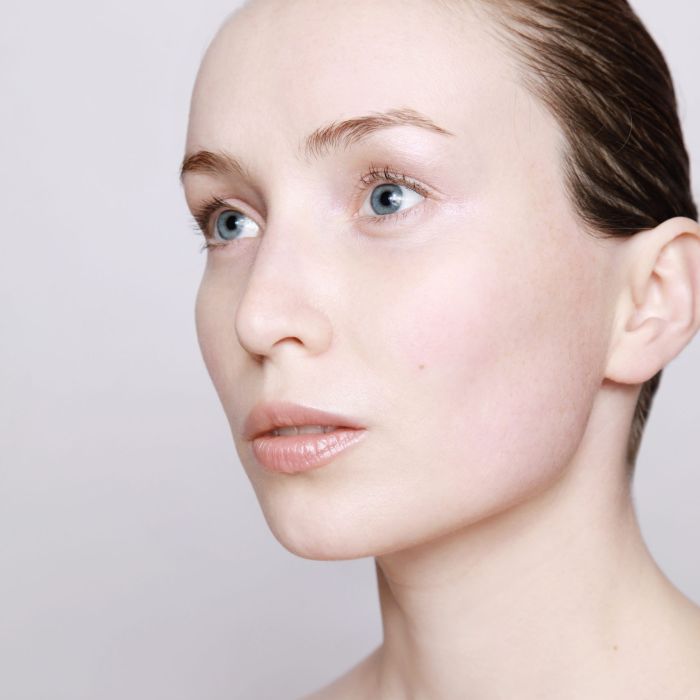 Woman with clear, calm skin &mdash; glycolic acid sensitive skin renewal, SACRA Cosmetics