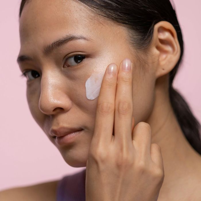 Woman with smooth hydrated skin using Sacra peptide skincare